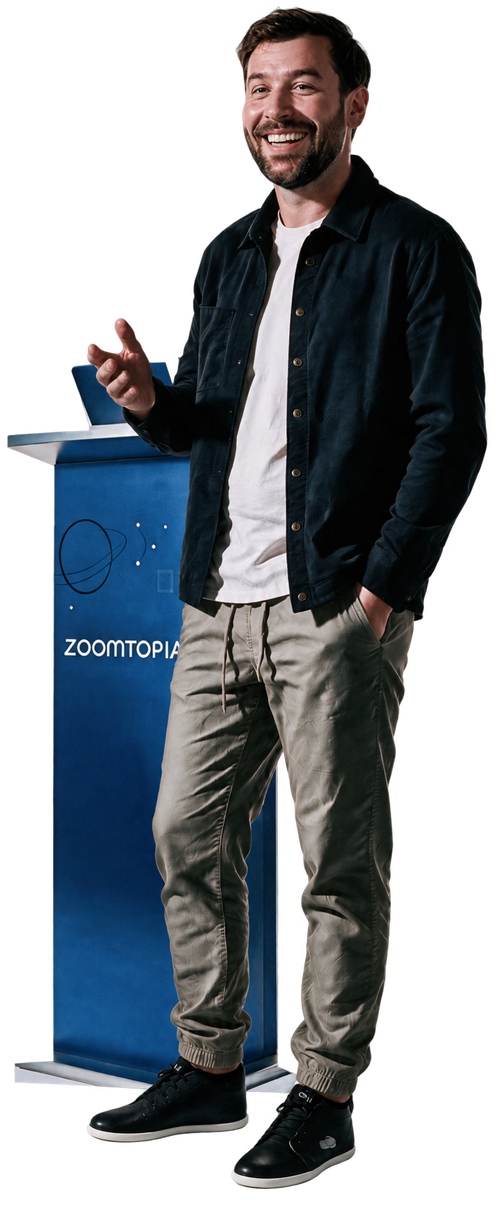 Ham Gordon smiling and standing beside a blue Zoomtopia podium