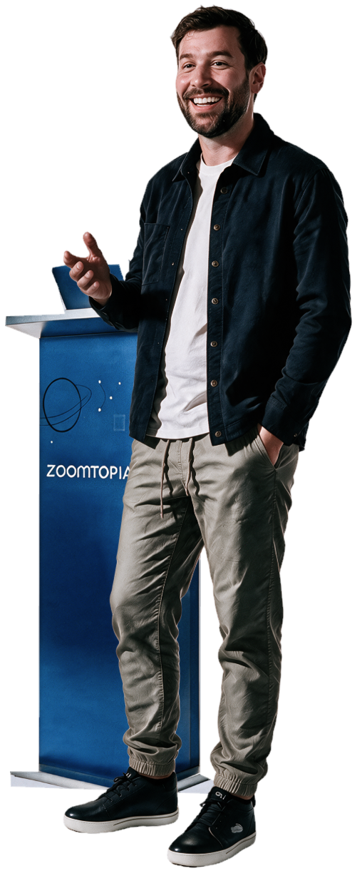 Ham Gordon smiling and standing beside a blue Zoomtopia podium